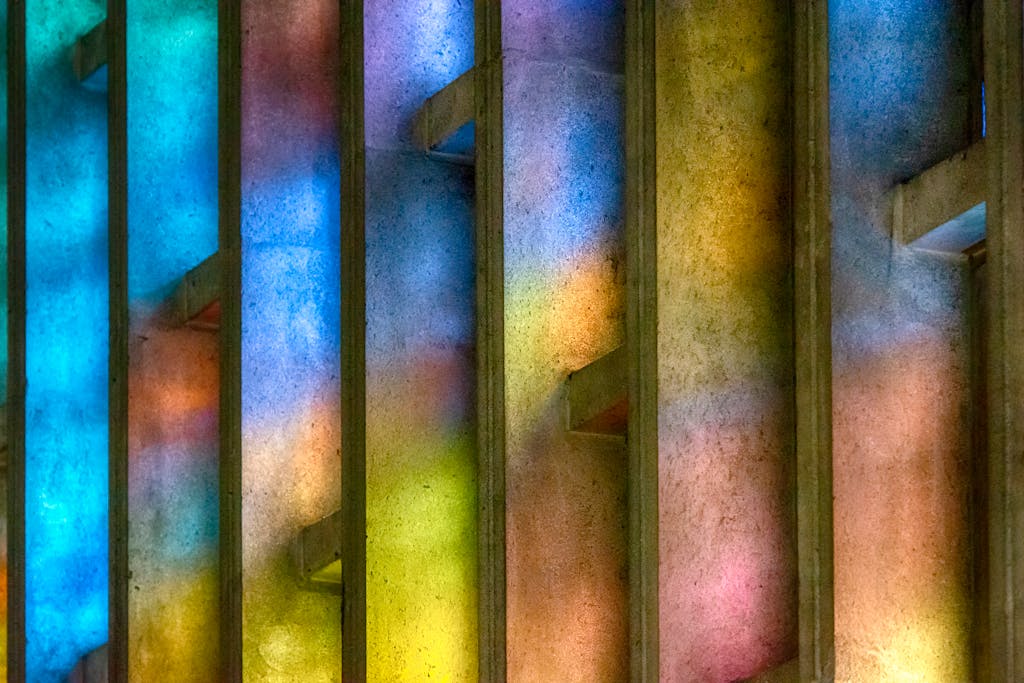 Abstract view of colorful light patterns on concrete walls through windows.